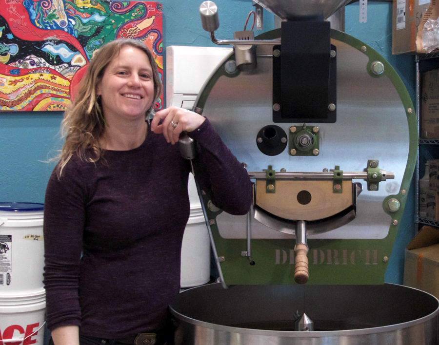 Ashley Linnekin poses with her coffee roaster at Ashley's Espresso Parlour, the newest coffee shop on the beach.