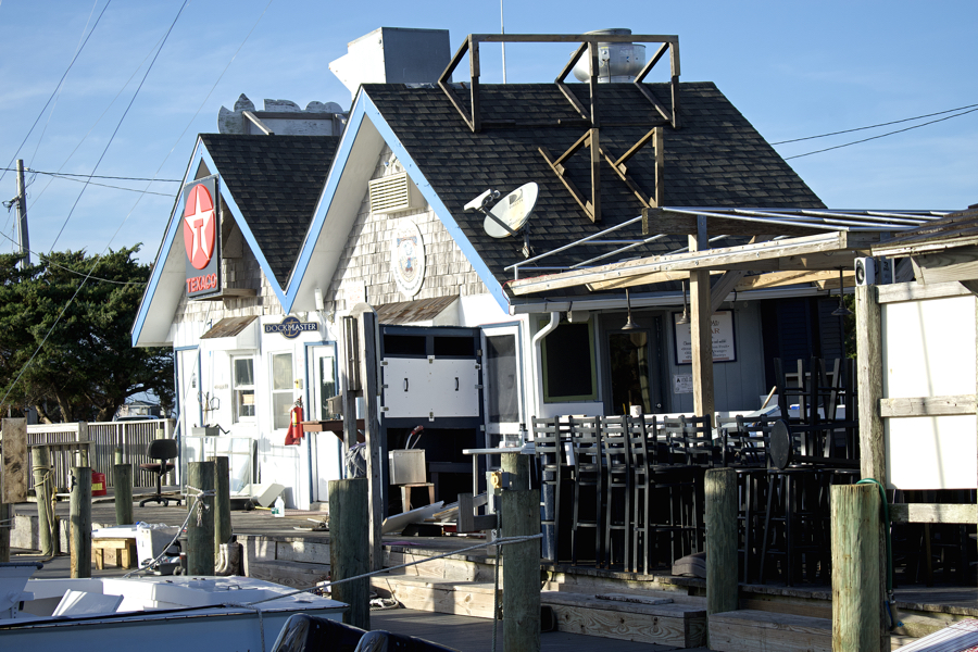 Where visitors gather to enjoy a drink and seafood by Silver Lake, a closed business and empty seats are the story.