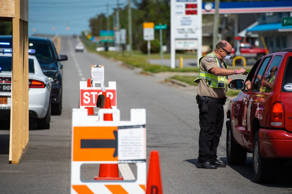 Dare County Sheriff checks ID at Virginia Dare Bridge in Manns Harbor. Photo Daniel Pullen for Huffington Post.